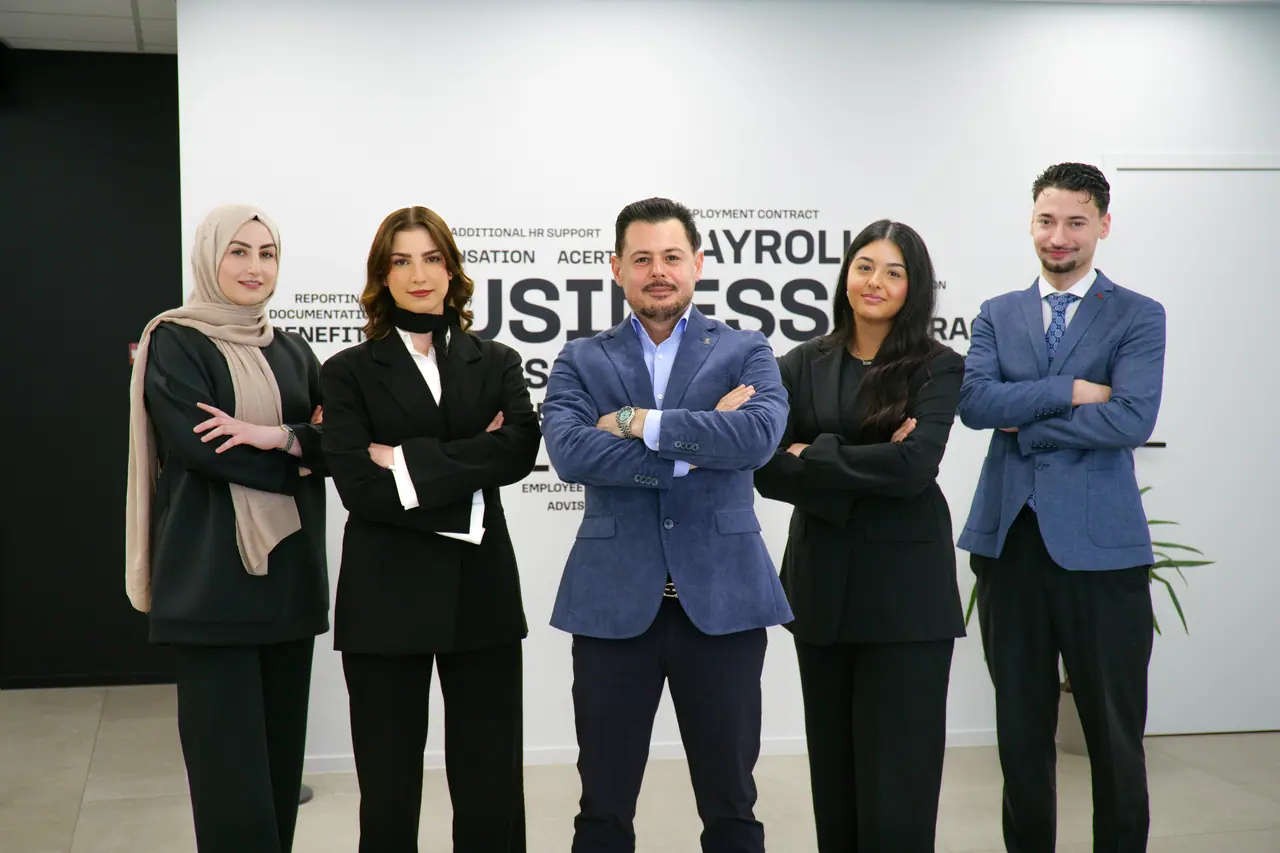 The Business Centrum team in front of their office wall