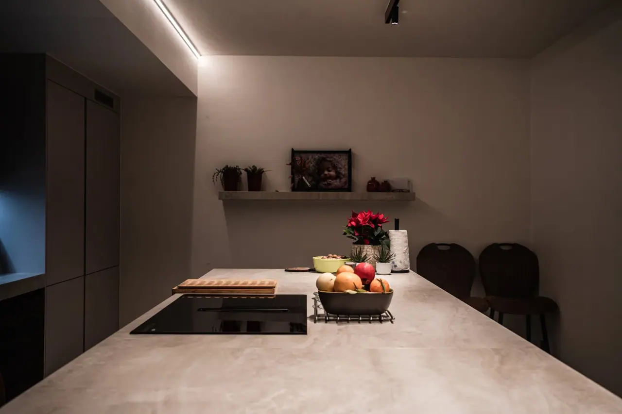 A finished SN Group kitchen with an island and a wall shelf