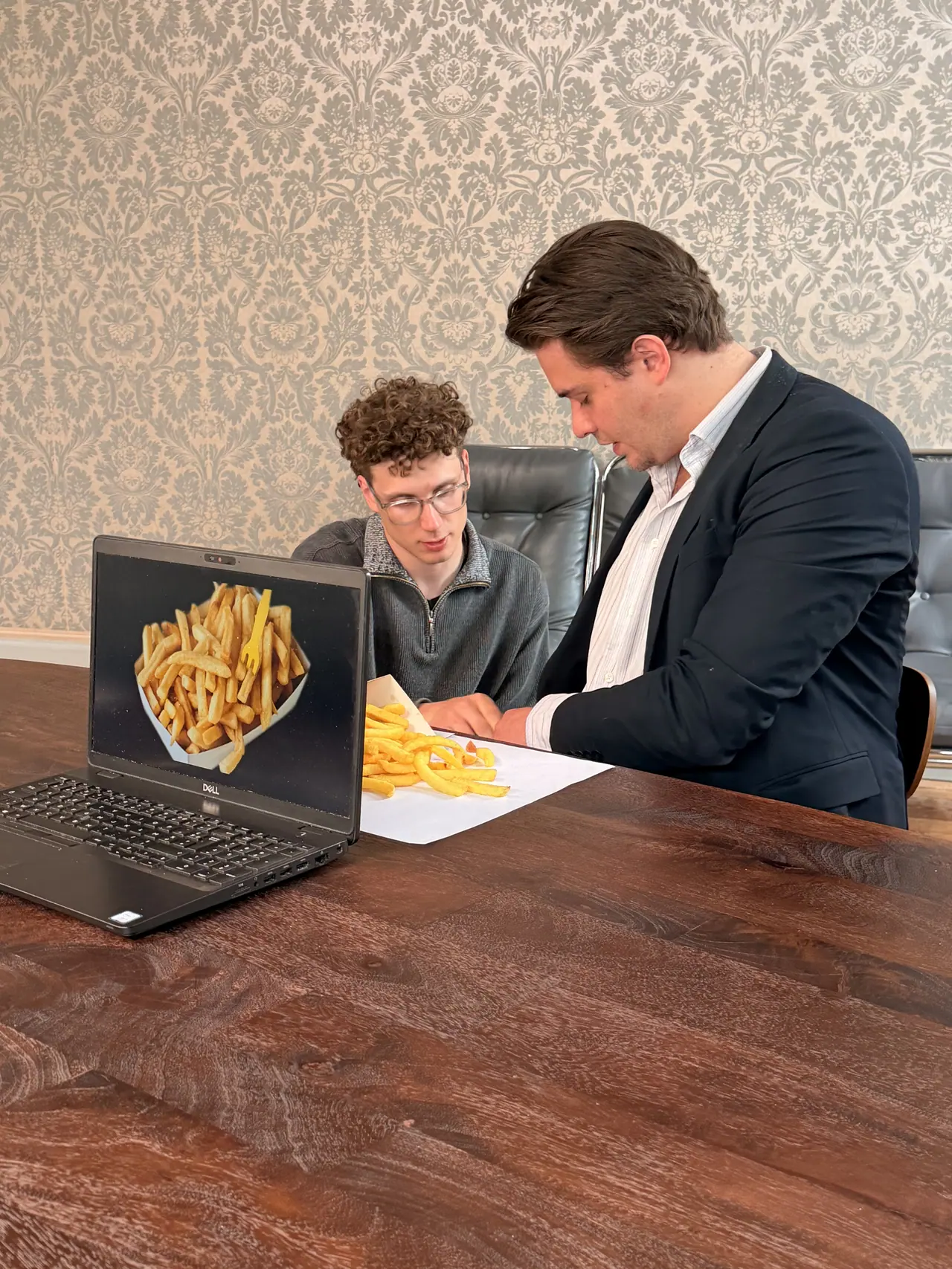 A product photo on a laptop, with the product itself beside it on the table